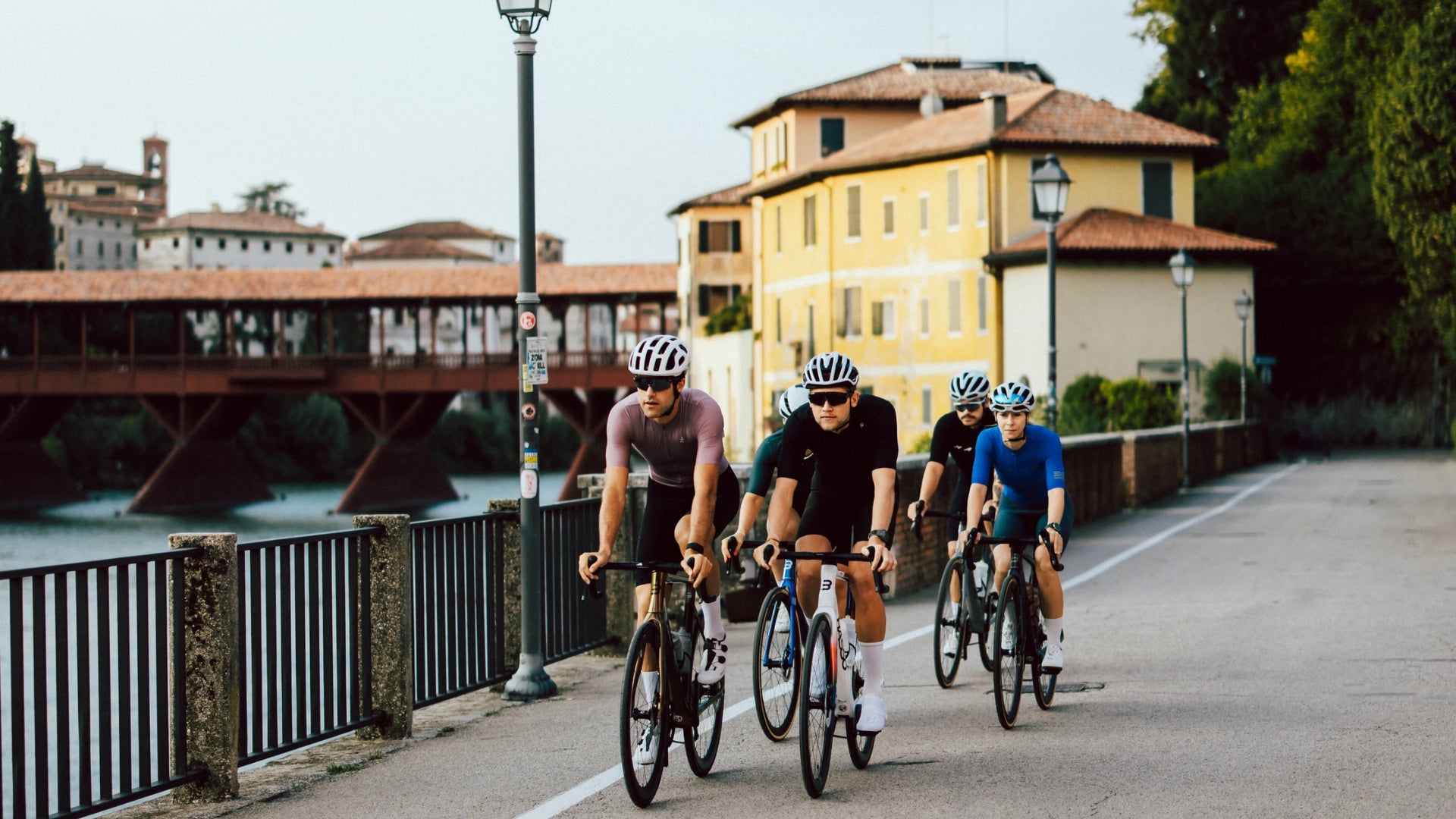 Basso cyclists beside the Ponte degli Alpini in Bassano del Grappa
