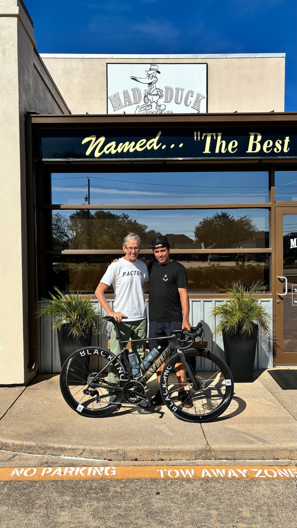 Felix with his Tavelo road bike outside Mad Duck Cyclery