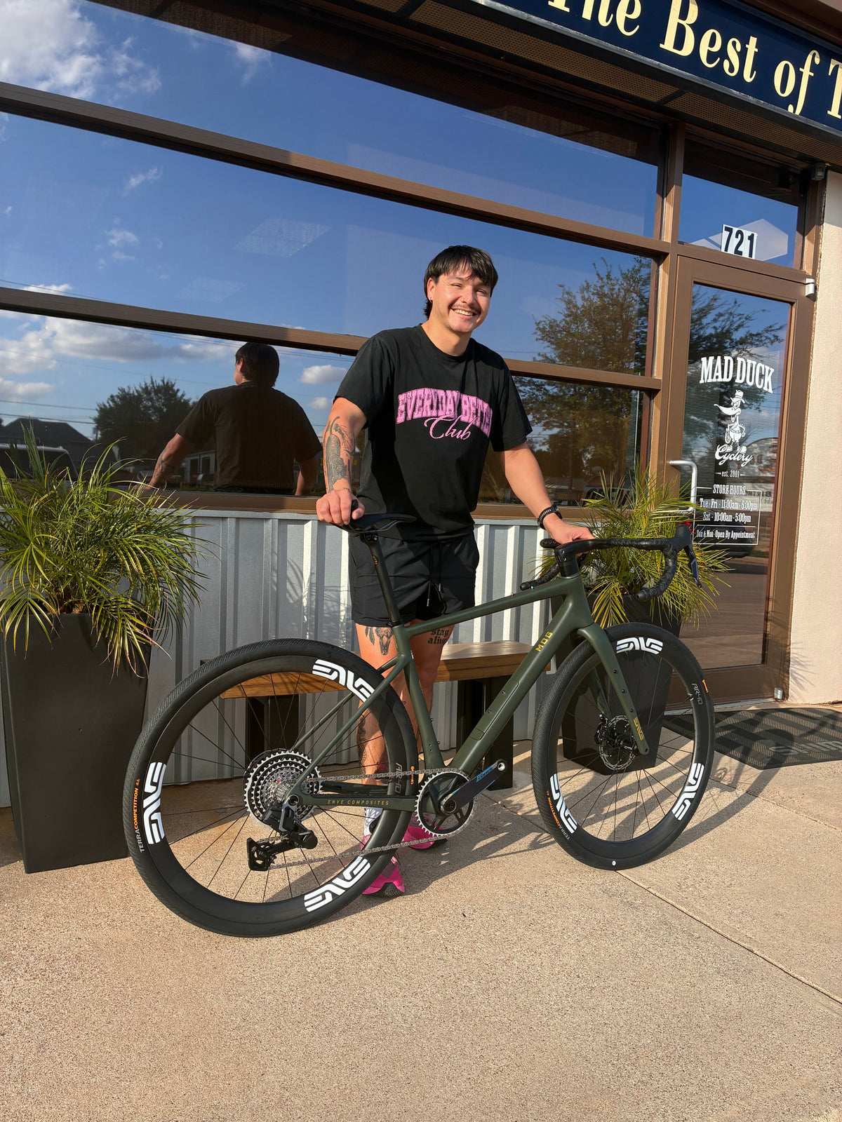 Corbin with his new green and gold ENVE MOG outside Mad Duck Cyclery